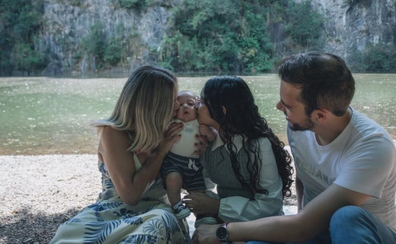 Family enjoying quality time together by the scenic riverside backdrop.